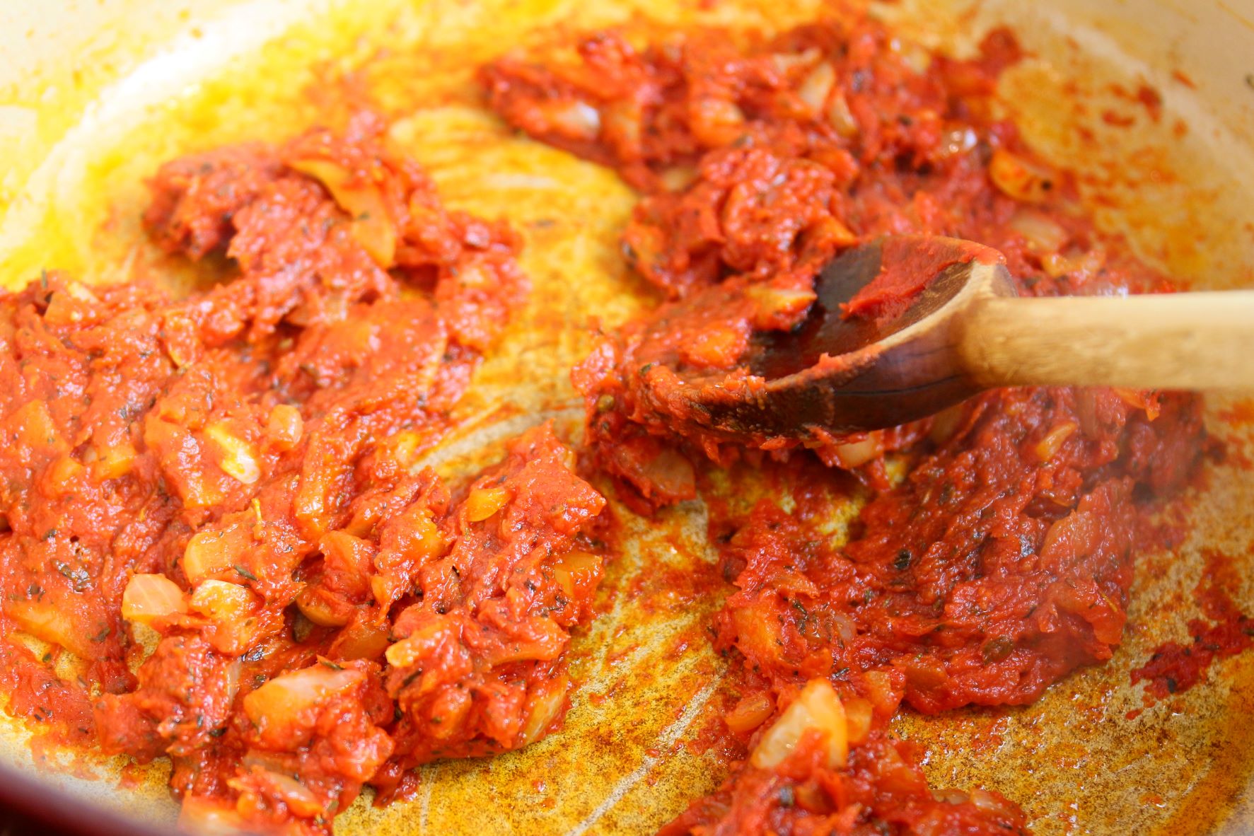 Cooking tomato paste for Bolognese Sauce