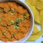 A bowl of Roasted Red Pepper and Pumpkin Seed Deep with Tortilla Chips