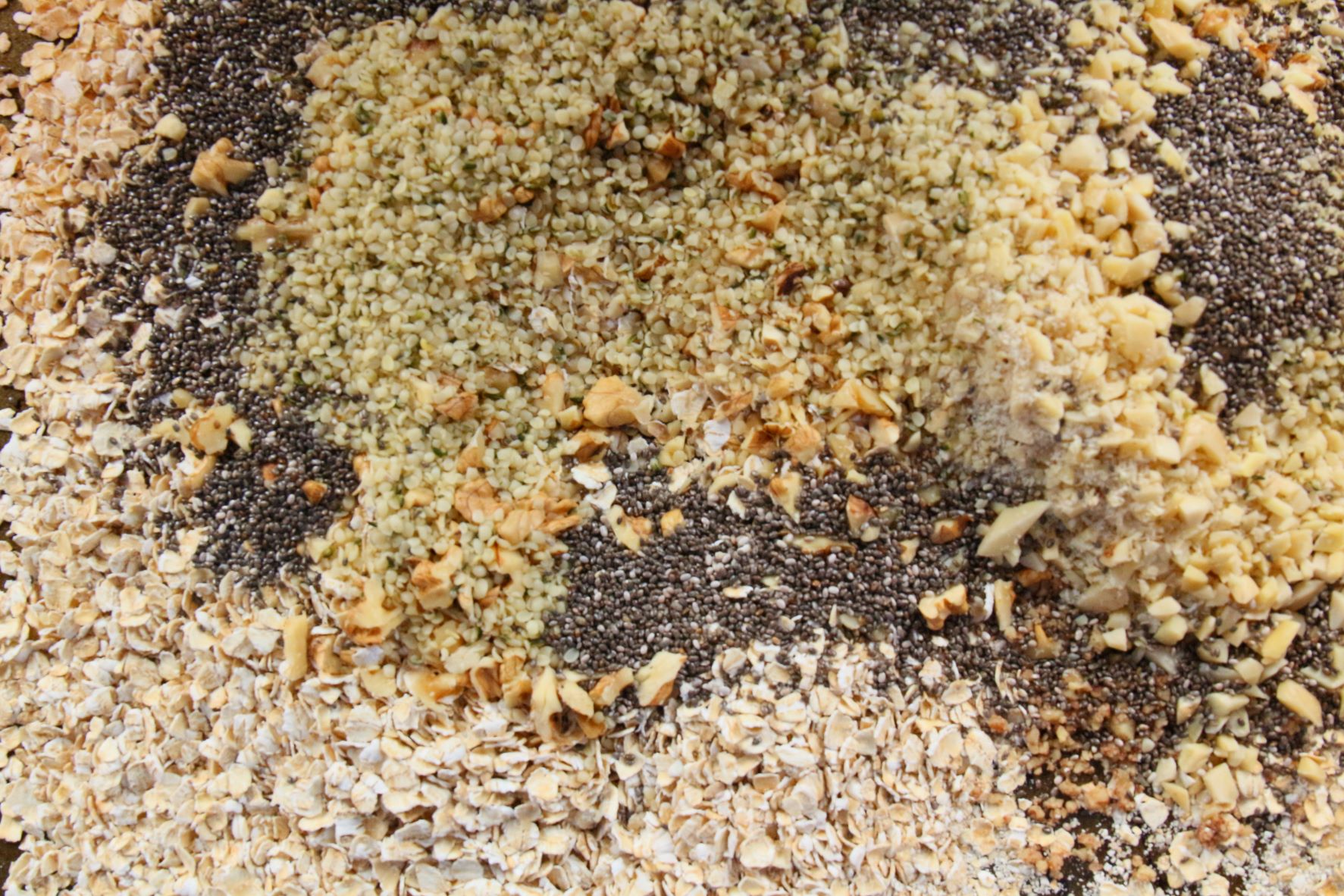 Sheet pan of toasted nuts and oats for granola bars